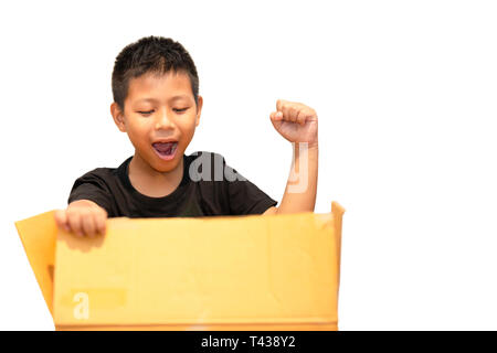 Boy surprised by opening parcel box isolated in clipping path Stock Photo