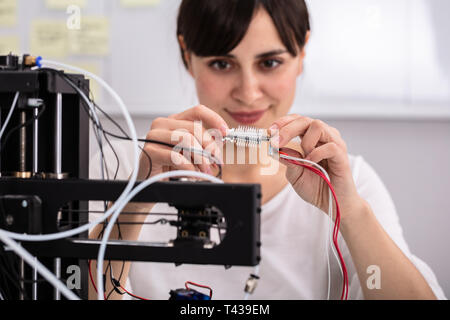 Smiling Confident Female Electrician Repairing Hardware Part Stock Photo