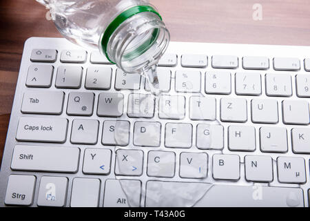 Close-up Of Spilled Water On Computer Keyboard Stock Photo