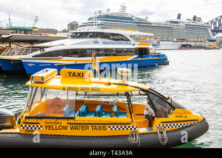 Water taxi, Manly fast ferry and cruise ship Celebrity Solstice all at Circular Quay harbour in Sydney ,Australia Stock Photo