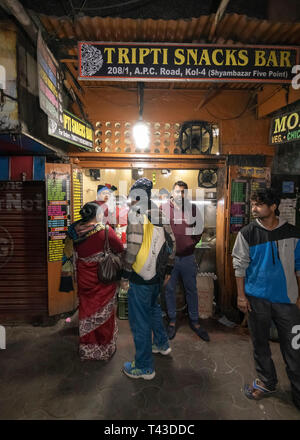 Vertical view of people waiting for food at a streetfood stand in Kolkata aka Calcutta, India. Stock Photo