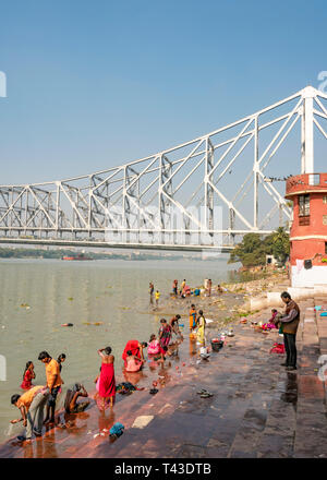 Vertical view of people washing at a ghat in the Hooghly river in Kolkata aka Calcutta, India. Stock Photo