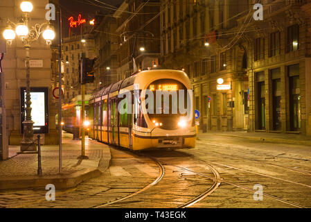 MILAN, ITALY - SEPTEMBER 28, 2017: Modern tram on the night street of the old town Stock Photo