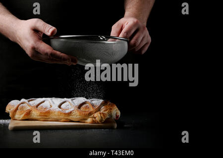 baker decorating on dark background. recipe concept. Stock Photo