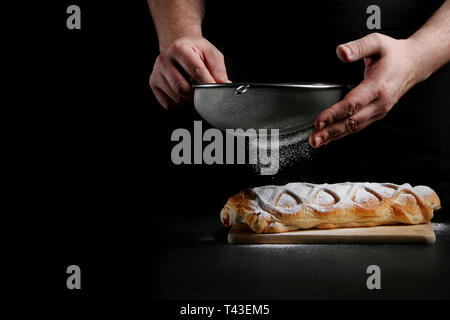 baker decorating on dark background. recipe concept. Stock Photo