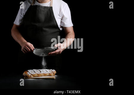 baker decorating on dark background. recipe concept. Stock Photo