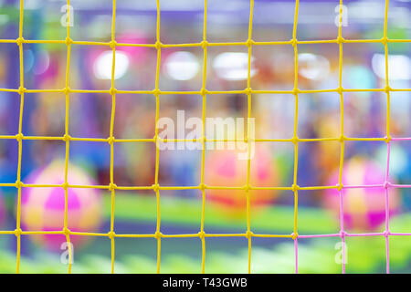 Multi-colored grid on the background of a blurred playground with balls and mazes Stock Photo