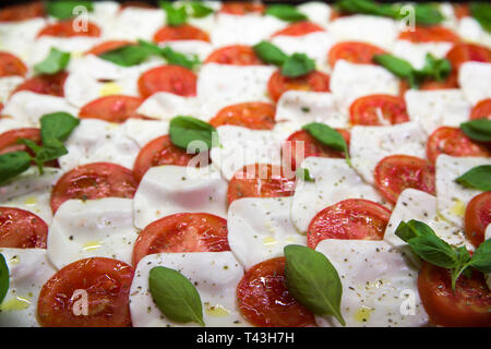 Tasty Italian pizza with tomatoes, basil and mozzarella. Stock Photo