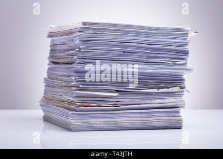 Photo Of Stacked Document Paper On Reflecting Backdrop Stock Photo