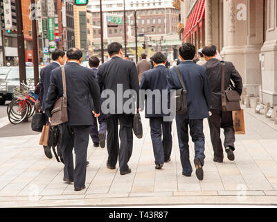 Group of salarymen walking together in the Nihombashi financial district, Tokyo, Japan Stock Photo