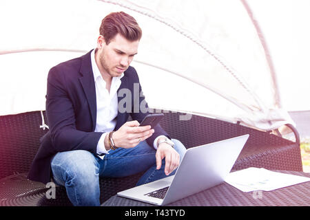 Stylish Young Adult Charming Handsome Businessman Working on Laptop on Outdoor Stock Photo