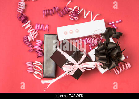 Set of gift boxes with bows, beads and ribbons on a colored background Stock Photo