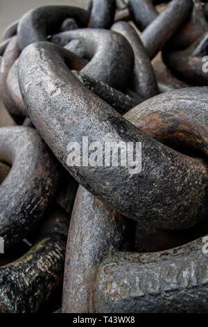 Detail on huge old ship chain, rust showing under paint in some parts. Stock Photo