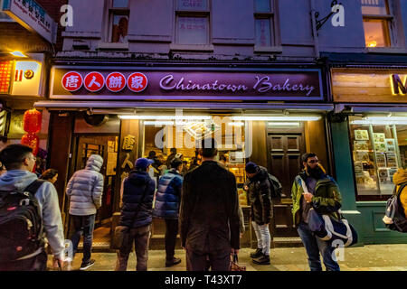 People outside a Chinatown Bakery in Chinatown ,London,UK Stock Photo