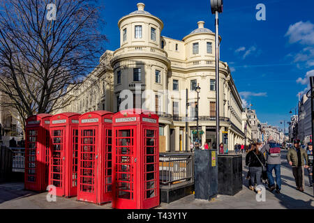 A row of Red public telephone boxes on The Strand at The junction with Duncannon St ,London, UK Stock Photo