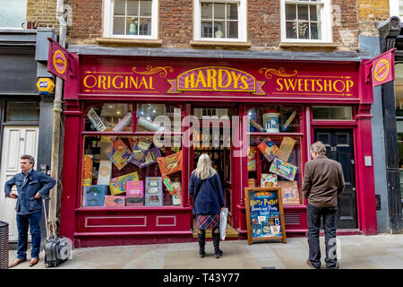 People looking at the window display of  Hardy's Original Sweetshop in New Row Covent Garden in London,UK Stock Photo