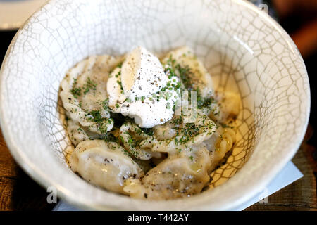 Delicious dumplings with cheese and onions in a bowl photographed close-up Stock Photo