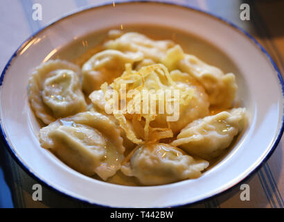 Delicious dumplings with cheese and onions in a bowl photographed close-up Stock Photo
