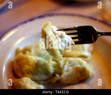 Delicious dumplings with cheese and onions in a bowl photographed close-up Stock Photo