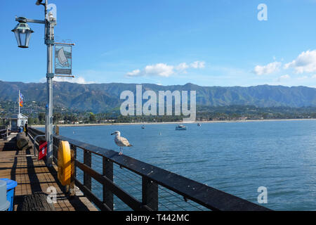 SANTA BARBARA, CALIFORNIA - APRIL 12, 2019:  Stearns Wharf with a seagull, the coastline and Santa Ynez Mountains in the background. Stock Photo
