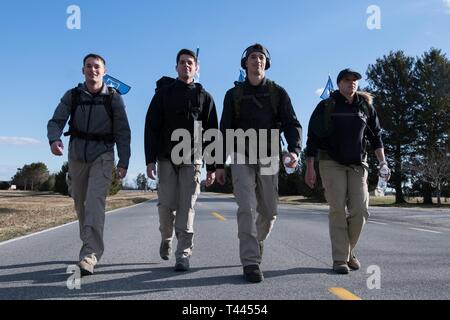 A group of Airmen from the 436th Security Forces Squadron walk in the 20th Annual Chosin Ruck March on March 16, 2019, at the Air Mobility Command Museum on Dover Air Force Base, Del. Participants had the option to register as individual runners or in teams of four. Stock Photo