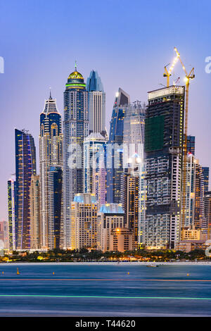 Stunning view of the illuminated Dubai Marina skyline during sunset. Picture taken from the  Palm Jumeirah artificial archipelago. Dubai Marina, Dubai. Stock Photo