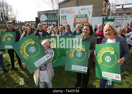 Aoibhe Clarke (left) gand daughter of late Irish Republican Terence 'Cleeky' Clarke, joins Sinn Fein's President Mary Lou McDonald and Vice President Mivhelle O'Neill for the launch of the Irish Unity Billboard in west Belfast, Saturday April 13th, 2019. Terence 'Cleeky' Clarke was Gerry Adam's body guard and passed away with cancer. The Launch took place at the former Andersonstown Police Station. Photo/Paul McErlane Stock Photo