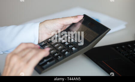 Businesswoman professional holding using office calculator calculate money, closeup Stock Photo