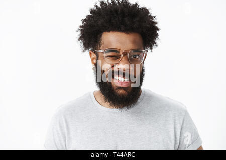 Hey smile. Portrait of optimistic and joyful handsome african american guy in good mood winking at camera friendly and grinning making positive impres Stock Photo