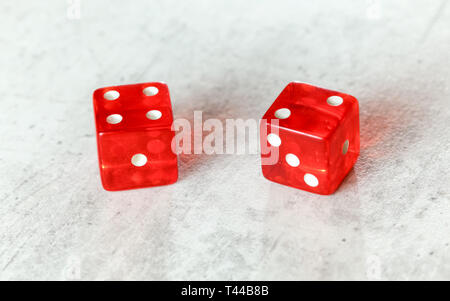 Two translucent red craps dices on white board showing Easy Six Jimmie Hicks umber 4 and 2  Stock Photo