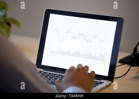 Rear view at african business man analyze annual financial report Stock Photo