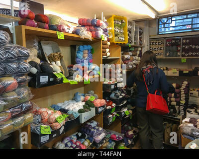 Messy racks filled with knitting wool and yard in the basement of a ...