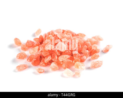 Himalayan pink salt in crystals on white background. Heap of pink salt isolated with clipping path. Stock Photo
