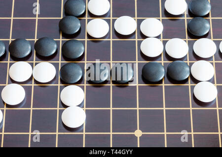 top view of playing in Go game on wooden board Stock Photo
