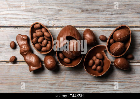 Chocolate easter bunny rabbits and eggs on a rustic wooden background Stock Photo