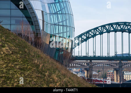 View of a section of the Sage Gateshead and Tyne Bridge against Newcastle cityscape. Stock Photo