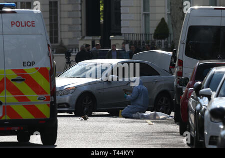 Forensic officers at scene near the Ukrainian Embassy in Holland Park, west London after police fired shots after the ambassador's car was 'deliberately rammed'. Stock Photo