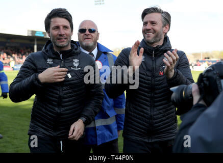 Lincoln City manager Danny Cowley (left) and assistant manager Nicky Cowley celebrate being promoted after the Sky Bet League Two match at Sincil Bank, Lincoln. Stock Photo