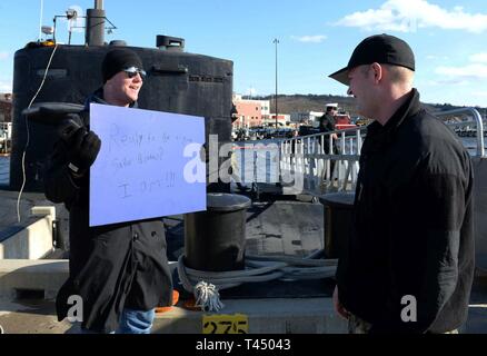 GROTON, Conn. (Feb. 25, 2019) Wyatt Shuman (left), younger brother of Sonar Technician (Submarines) Third Class Burke Shuman (right), welcomes his brother home with surprise news that he has joined the Navy too and will leave for boot camp to be an Aviation Boatswain’s Mate in July of this year during a homecoming celebration for the Los Angeles-class, fast-attack submarine USS Pittsburgh (SSN 720), on Naval Submarine Base New London in Groton, Conn. Pittsburgh is returning from the European Command Area of Responsibility where they executed the Chief of Naval Operation’s Maritime Strategy in  Stock Photo