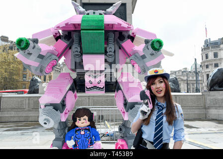 London, UK.  13 April 2019. A staff member presents LEGO Overwatch’s 3m high D.VA statue, made from 150,000 LEGO bricks at the Trafalgar Square Games Festival, the climax of the London Games Festival, an event supported by The Mayor of London. In addition, leading FIFA players representing Chelsea FC and Wolverhampton Wanderers team up with a member of the public to play FIFA 2019.   Credit: Stephen Chung / Alamy Live News Stock Photo