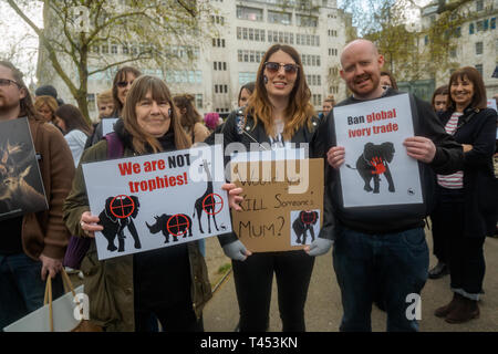 London, UK. 13th April 2014. People meet in Cavendish Square to march through London  to a rally opposite Downing St as a part of the 2019 Global March for Elephants and Rhinos. They called on the UK government to impose a ban on the import of hunting trophies of endangered species to the UK, and supported an increase in the protection under CITES for elephants and opposed attempts to downgrade protection of endangered species or reopen trade in ivory and other body parts. Peter Marshall/Alamy Live News Stock Photo