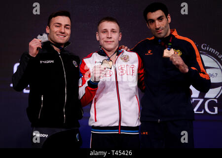 Szczecin, West Pomeranian, Poland. April 13, 2019 - Szczecin, West Pomeranian, Poland - Marco Lodadio from Italy, Denis Abliazin from Russia and Vahagn Davtyan from Armenia are seen with medals on the award ceremony of the rings final during Apparatus Finals of 8th European Championships in Artistic Gymnastics Credit: Mateusz Slodkowski/SOPA Images/ZUMA Wire/Alamy Live News Stock Photo