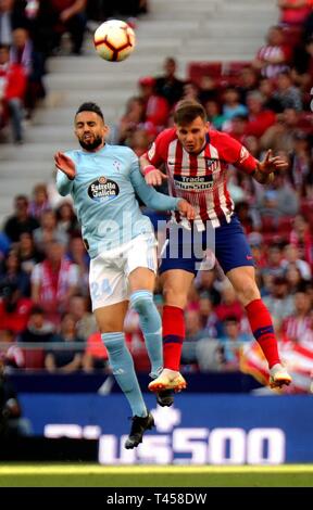 Madrid, Spain. 13th Apr, 2019. Celta's Ryad Boudebouz (L) and Atletico Madrid's Saul Niguez vie for aerial during a Spanish league match between Atletico Madrid and Celta de Vigo in Madrid, Spain, on April 13, 2019. Atletico Madrid won 2-0. Credit: Edward F. Peters/Xinhua/Alamy Live News Stock Photo