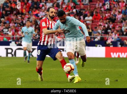 Madrid, Spain. 13th Apr, 2019. Atletico Madrid's Juanfran Torres (L) and Celta's Sofiane Boufal compete during a Spanish league match between Atletico Madrid and Celta de Vigo in Madrid, Spain, on April 13, 2019. Atletico Madrid won 2-0. Credit: Edward F. Peters/Xinhua/Alamy Live News Stock Photo