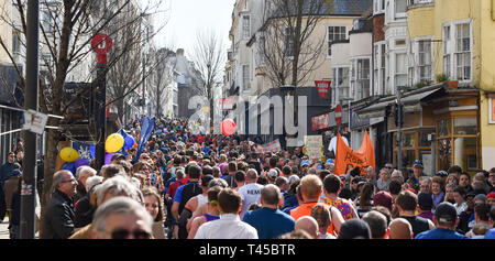 Brighton, Sussex, UK. 14th Apr, 2019. Thousands of runners and spectators in the narrow St James's Street area of Brighton take part in this years Brighton Marathon which is celebrating its 10th anniversary Credit: Simon Dack/Alamy Live News Stock Photo