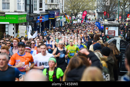 Brighton, Sussex, UK. 14th Apr, 2019. Thousands of runners and spectators in the narrow St James's Street area of Brighton take part in this years Brighton Marathon which is celebrating its 10th anniversary Credit: Simon Dack/Alamy Live News Stock Photo