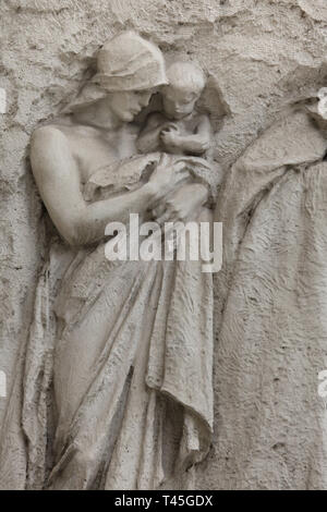 Art Nouveau relief by Czech sculptor Stanislav Sucharda flanking the main entrance to the Prague New City Hall (Nová radnice) in Mariánské Square in Staré Město (Old Town) in Prague, Czech Republic. The Art Nouveau building designed by Czech architect Osvald Polívka was built in 1908-1911. The relief on the left side depicting: Citizens bearing a load together, i.e. it stresses out the principle of group work and obligations. Stock Photo