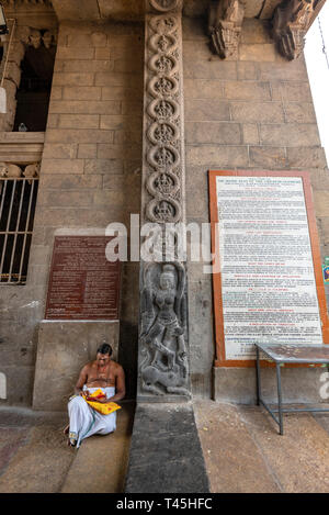 Vertical portrait of a traditionally dressed man sitting in the Kapaleeshwarar Temple in Chennai, India. Stock Photo