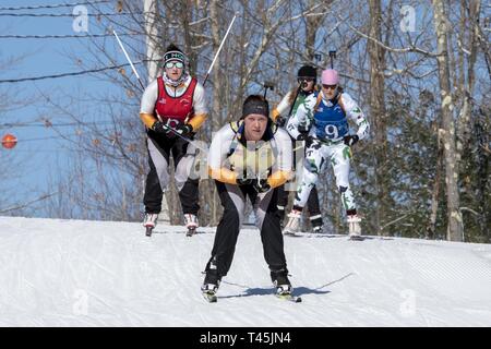 Athletes compete in the 2019 Chief, National Guard Bureau Biathlon Championship Patrol Race, Camp Ethan Allen Training Site, Jericho, Vt., Feb. 28, 2019. The CNGB Championships consist of the sprint, pursuit, patrol, and relay race. Stock Photo