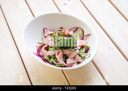 Salad with red and white cabbage, fresh cucumber and slices of ham Stock Photo